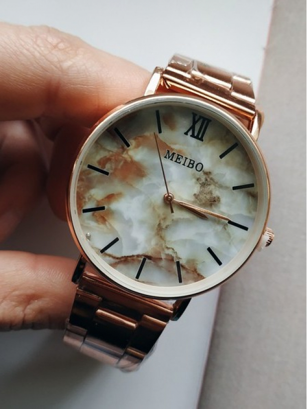 Gold watch with a beige marble dial
