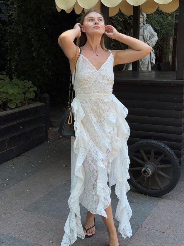 White lace dress with asymmetrical ruffles